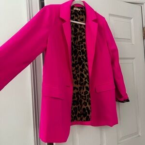 A pink blazer with a cheetah print inner, the pink is less bright than pictured.